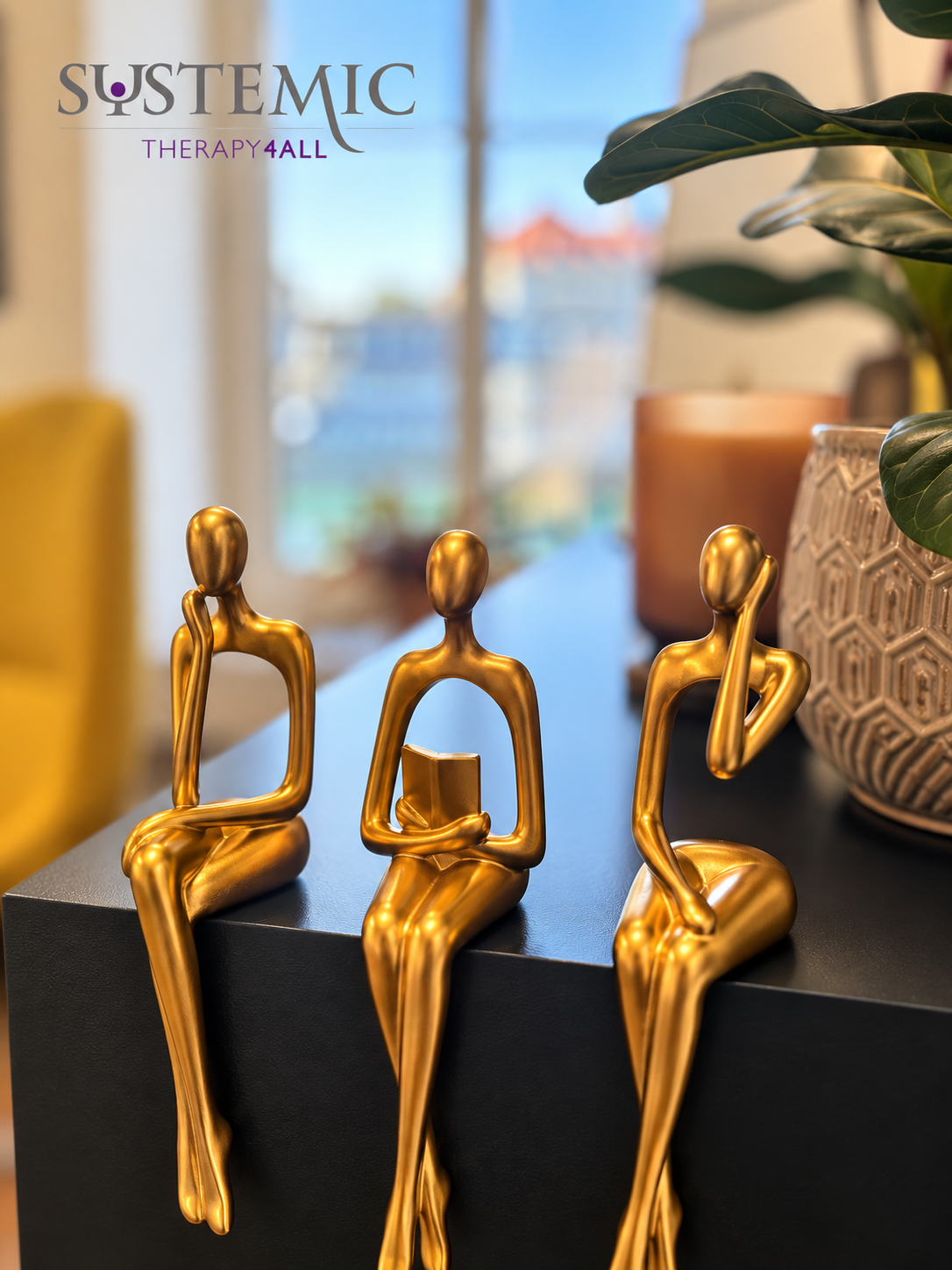 Three small golden figurines on a shelf